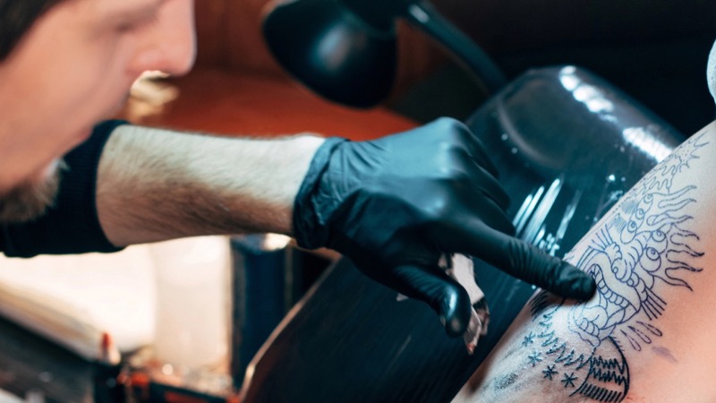 Man getting shoulder tattoo