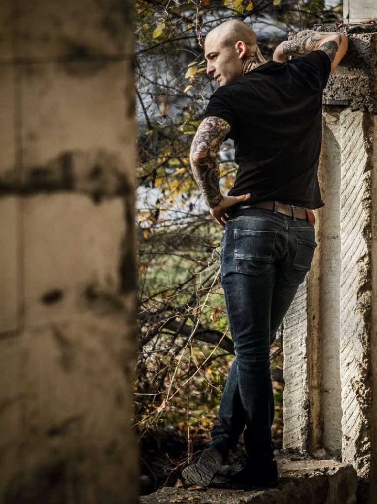 Bald man with tattoos photographed from the back