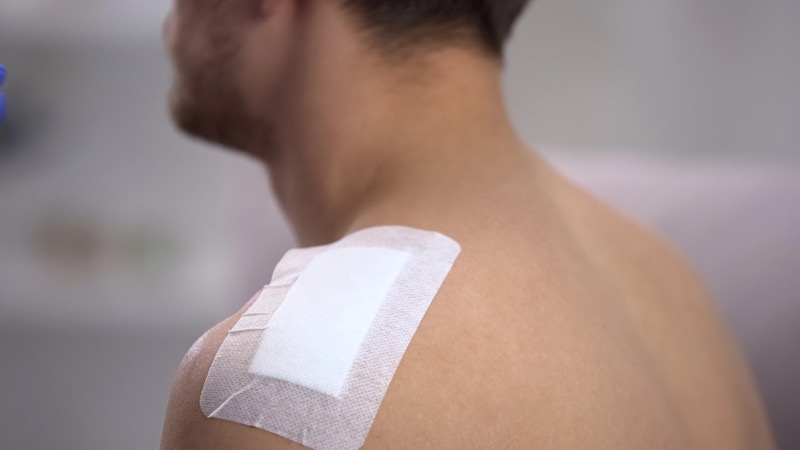 Man with bandage on shoulder