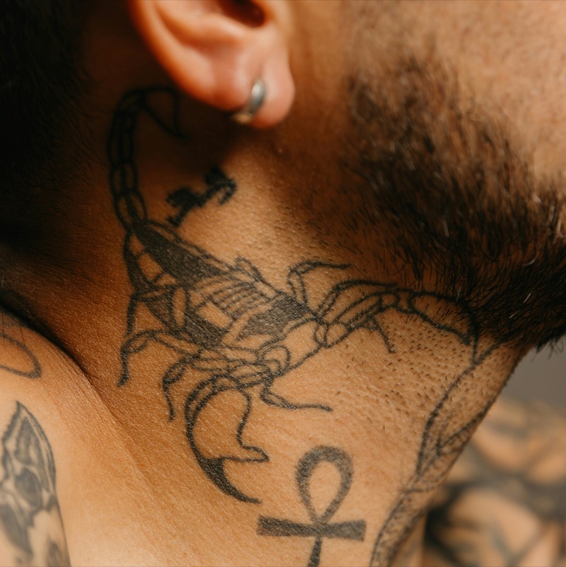 Scorpion neck tattoo