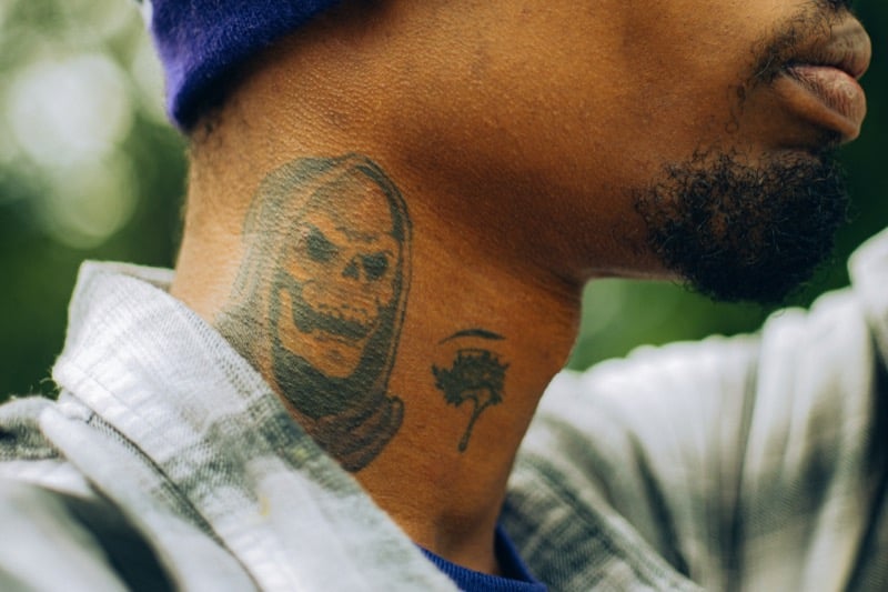 Skull neck tattoo