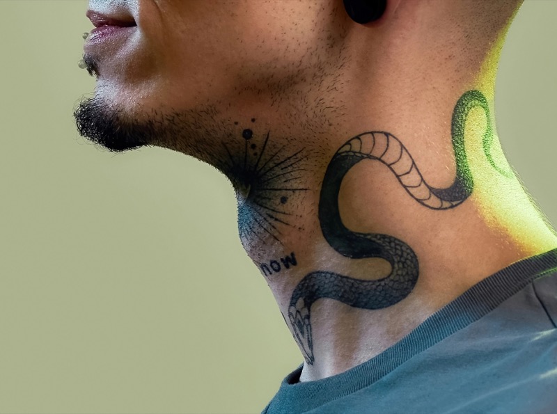 Snake side neck tattoo