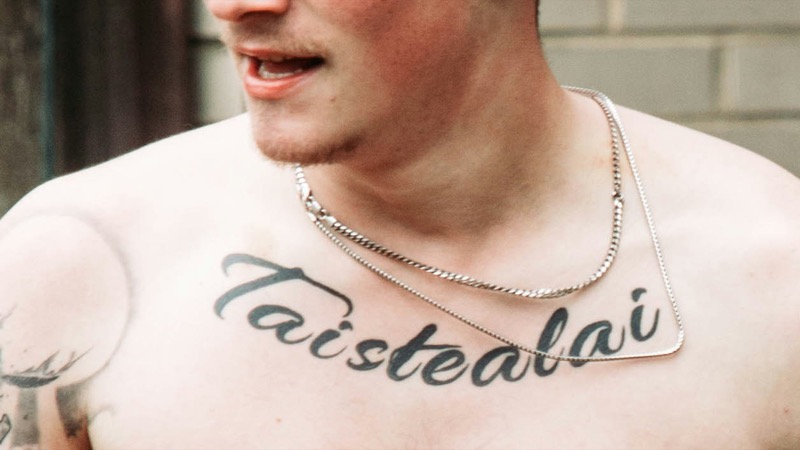 collarbone horizontal script chest tattoo men