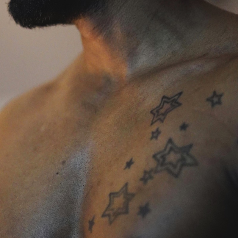 small fine line star chest tattoo men