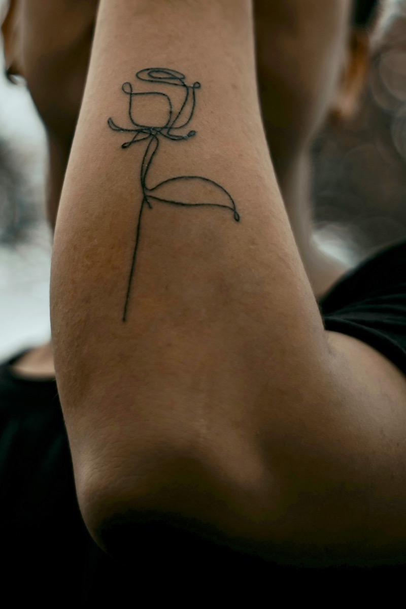 small rose forearm tattoo men