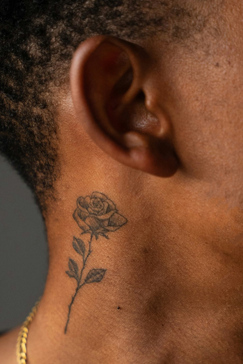 small rose neck tattoo men