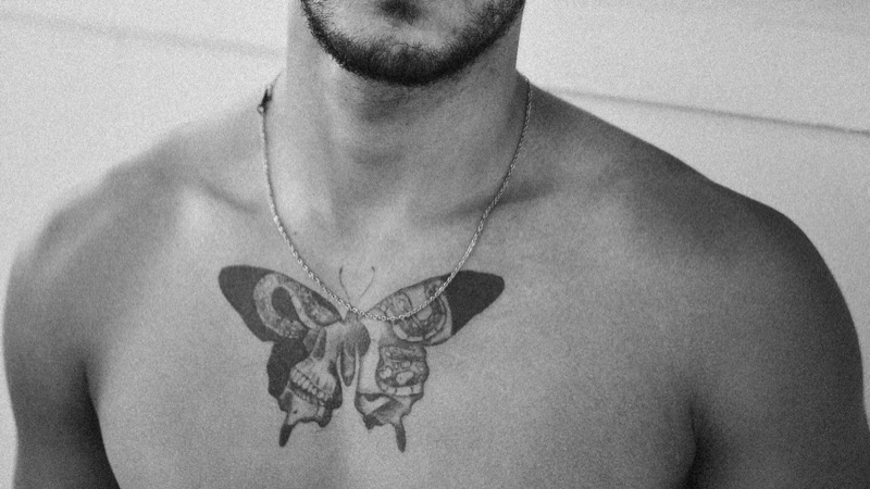 sternum butterfly skull chest tattoo men